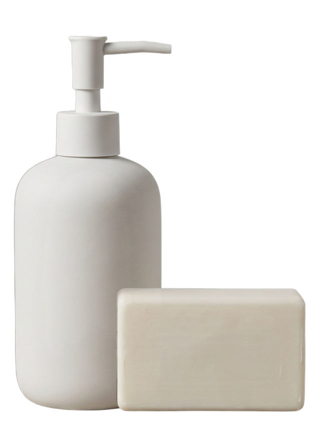 A generic, unbranded soap dispenser and plain bar of soap